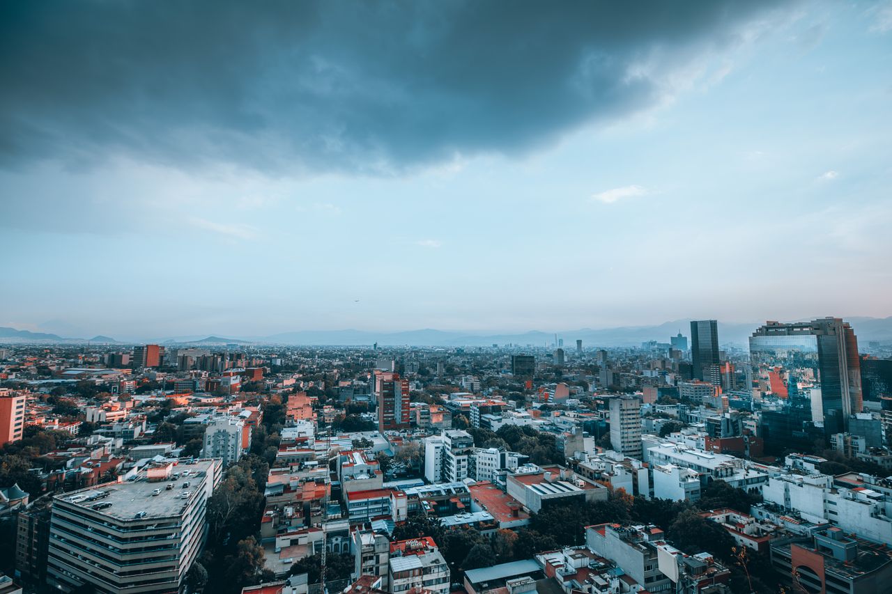 Breathtaking aerial panorama of Ciudad de México with dramatic sky.